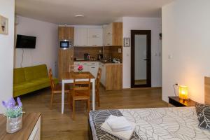 a living room and kitchen with a couch and a table at D'arte Studio in Balchik +5 photos