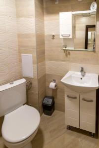 a bathroom with a toilet and a sink at D'arte Studio in Balchik