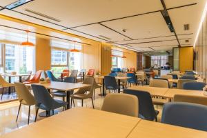 a dining room with tables and chairs and windows at Holiday Inn Express Xi'an North by IHG in Xi'an