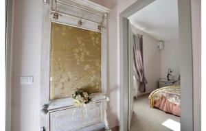 a bedroom with a bed and a dresser with flowers on it at 2 Bedroom Stunning Home In Camaiore in Camaiore +9 photos