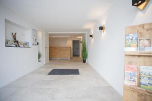 a hallway with white walls and a tile floor at Winterbergerstrasse 3, Winterberg-Neuastenberg 'Wintertraum' in Winterberg