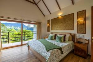 a bedroom with a bed and a large window at amã Stays & Trails - Werifesteria, Coonoor in Coonoor