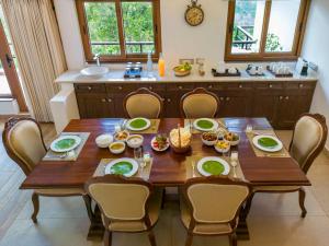 a wooden table with chairs around it in a kitchen at amã Stays & Trails - Werifesteria, Coonoor in Coonoor +31 photos