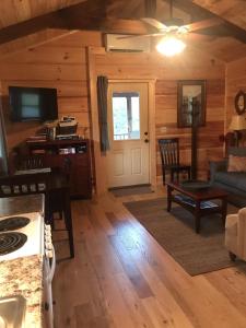 a kitchen and living room in a log cabin at Pet Friendly, Peaceful Cabin Near Wineries, in Tryon
