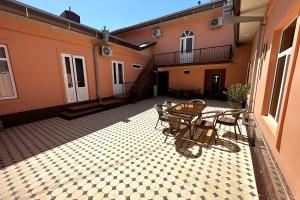 a patio with a table and chairs on a courtyard at OLD STREET Guest House in Samarkand