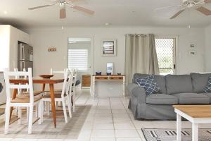 a living room with a couch and a table at KIAMA AMITY POINT in Amity Point