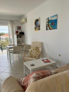 a living room with a couch and a table at Dina Apartment in Skala