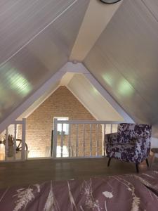 a room with a chair in a attic at Mariahoeve in Rilland