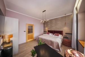 a bedroom with a bed and a living room at Penzion Martina**** in Lanškroun