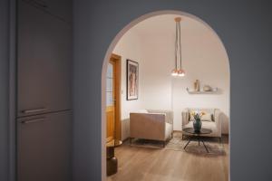 an archway leads into a living room with a table and chairs at Penzion Martina**** in Lanškroun