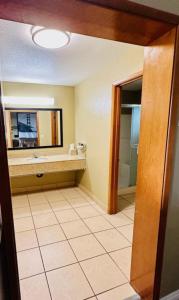 a bathroom with a sink and a mirror at Super 8 by Wyndham Crescent City in Crescent City