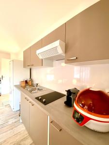a kitchen with a red appliance on a counter at Appartement rénové 80 m2 in Foix