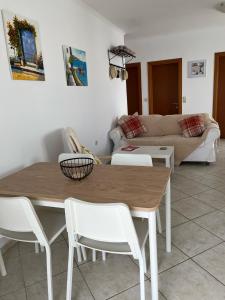 a living room with a table and chairs and a couch at Dina Apartment in Skala Kefalonias