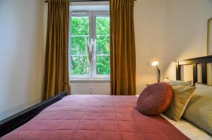 a bedroom with a large bed with a large window at CITYSTAY Old Town Gdansk Apartment in Gdańsk