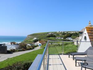 a view of the ocean from the balcony of a house at Trelawns in Mawgan Porth