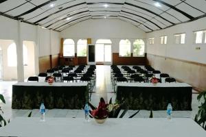 a large room with tables and chairs in it at Hotel Pesona Ciwidey in Ciwidey