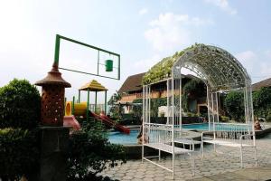 a swimming pool with a water park with a water slide at Hotel Pesona Ciwidey in Ciwidey