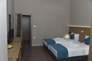 Postel nebo postele na pokoji v ubytování Harmony Hotel