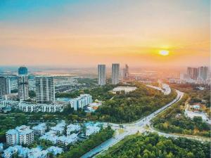 an aerial view of a city at sunset at Cyberjaya Menara Eclipse Fully Air Con Suite with Garden View, Cyber 11, 63000 Cyberjaya in Cyberjaya