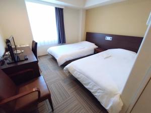 Postel nebo postele na pokoji v ubytování New Matto Terminal Hotel