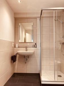 a bathroom with a sink and a shower at Ferienhaus Geiger in Bernau im Schwarzwald in Bernau im Schwarzwald