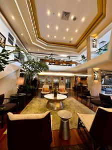 a lobby of a hotel with a table and chairs at Luana Waikiki Park Views in Honolulu