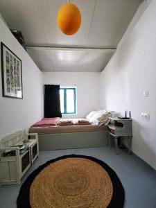 a bedroom with a bed and a large rug at tiny house EFROSSINI in Krásion