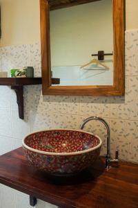 a bathroom sink with a large bowl and a mirror at laolulodge in Luang Prabang