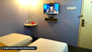 a hospital room with two beds and a tv at Bright Boutique Hotel Kelana Jaya in Petaling Jaya