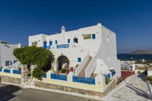 a large white building with blue accents at Agnadi studios in Maltezana