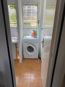 a bathroom with a washing machine and a sink at 3 BDRM APART NEAR THE SEA! GREAT FOR KIDS! in Arenys de Mar