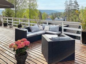 a couch sitting on top of a deck at Holiday home NESØYA in Sandvika