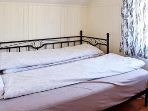 two beds in a bedroom with white sheets at Apartment Frederikstad in Fredrikstad