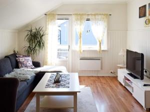 a living room with a couch and a coffee table at Apartment Frederikstad in Fredrikstad
