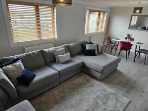 a living room with a couch and a table at No 40 Perfect Trades part of Langley Serviced Apartment in Wick