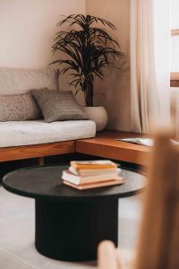 a coffee table in a living room with a couch at MAZI - Pied à Terre in Rethymno