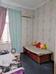 a small room with a bed and a window at Friendly Guest House in Kutaisi