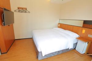 Postel nebo postele na pokoji v ubytování 盤古捷旅 - Panco Hotel