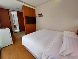 Postel nebo postele na pokoji v ubytování 盤古捷旅 - Panco Hotel