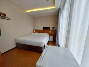 Postel nebo postele na pokoji v ubytování 盤古捷旅 - Panco Hotel