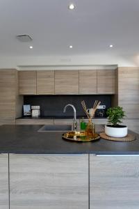 a kitchen with a sink and a counter top at Villas les Capucines in Sète