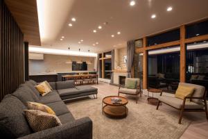 a living room with a couch and a table at Akiyama in Kutchan