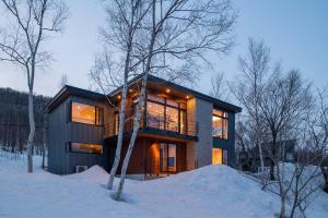 a house in the snow in the woods at Akiyama in Kutchan