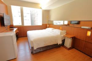 Postel nebo postele na pokoji v ubytování 盤古捷旅 - Panco Hotel