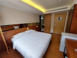 Postel nebo postele na pokoji v ubytování 盤古捷旅 - Panco Hotel