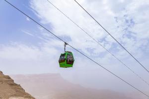 a cable car in the sky over a mountain at Tolip Resort El Galala Majestic in Ain Sokhna