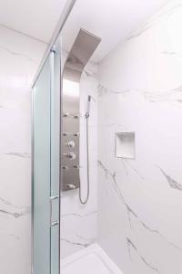a shower in a bathroom with white marble walls at Apartment in Silo/Insel Krk 13445 in Šilo