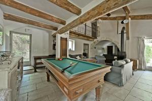 a living room with a pool table in it at Mas Arguin - Charmante maison avec piscine in Barjac