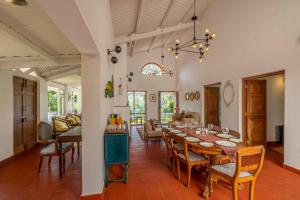a dining room and living room with a table and chairs at amã Stays & Trails - Aberdeen, Coonoor in Wellington Town