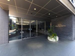 a lobby of a building with a sign that reads right wolf furniture at Villa Fontaine Tokyo Kudanshita in Tokyo +12 photos